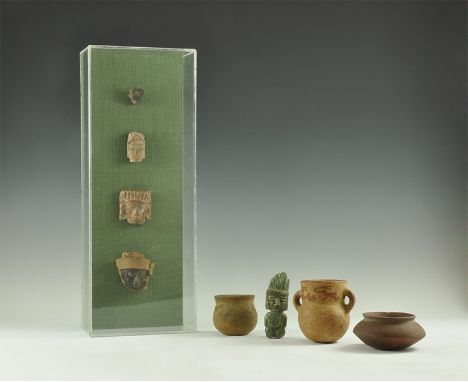20th century AD and earlier. A mixed group comprising: four small ceramic masks in a custom-made display case; a squat biconi