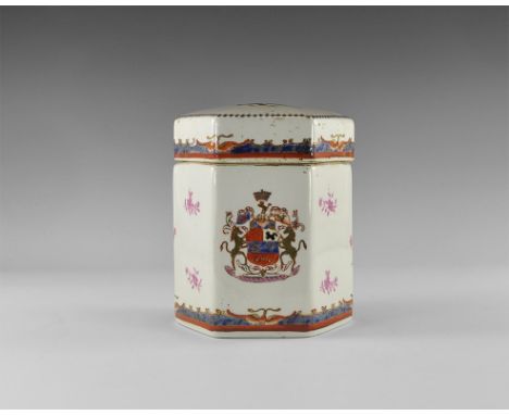 20th century AD. A white-glazed ceramic hexagonal-section jar and lid, with polychrome heraldic achievement design to two lat