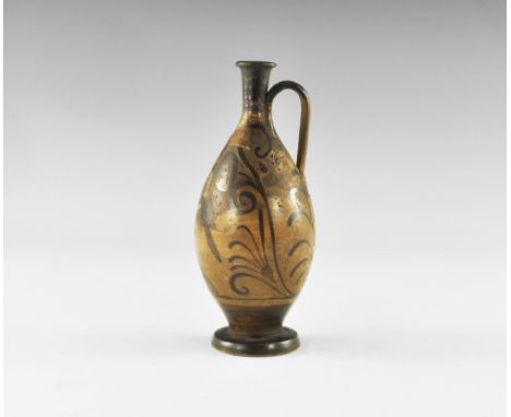 19th century AD. A piriform glazed ceramic lekythos with pedestal base, slender neck, flared rim and ribbed strap handle to t