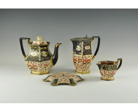 Early 20th century AD. A tea service in dark blue, cream and orange glazed ceramic with gold highlights comprising: tea pot a
