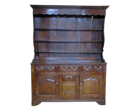 Late 18th century oak Welsh dresser, shaped canopy with ogee mould, three fixed graduated shelves with planked back, base fit