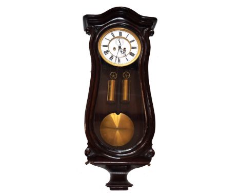 A 19th century double weight mahogany Vienna regulator. The serpentine case has rounded arched pediment and glass side panels