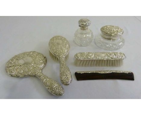 Six piece silver dressing table set comprising hand mirror, hair brush, clothes brush, comb and two silver mounted glass jars