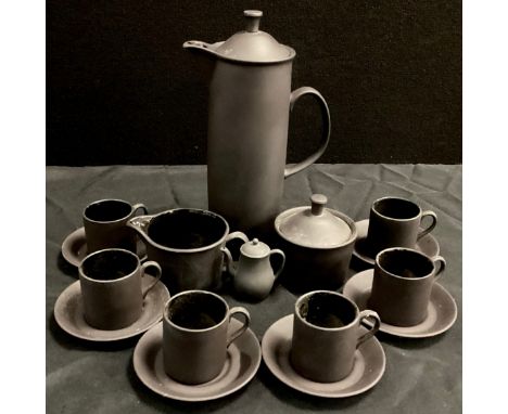 A Wedgwood black basalt coffee service for six comprised of; a coffee pot,27cm long, milk jug, sugar pot, six coffee cans and
