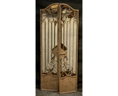 A wrought iron archtop garden gate mirror, scrolling doors, 129cm high, 54cm wide 