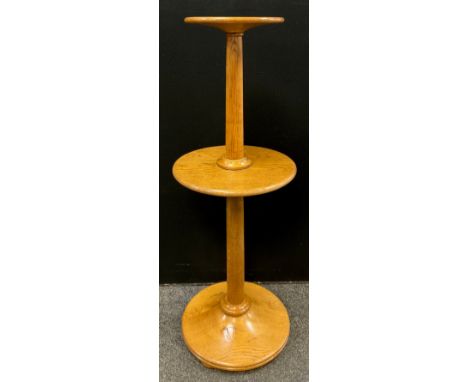 A hand crafted oak Ram furniture dumbwaiter lamp stand, circular top and shelf, plain turned column stepped base, 125cm high,