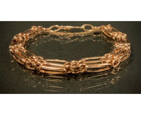 A 9ct gold fancy link gate bracelet, 8mm wide, 15g gross 