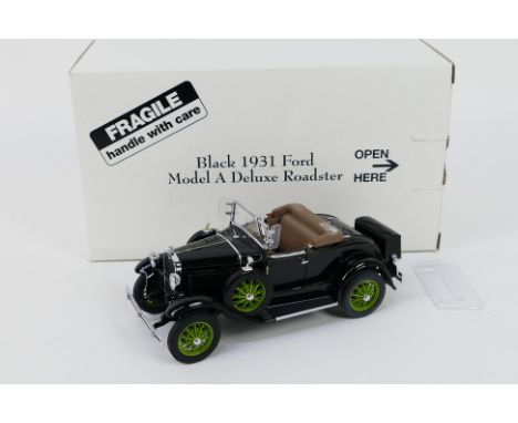 Danbury Mint - A boxed Danbury Mint 1:24 scale Black 1931 Ford Model A Deluxe Roadster. The model bears some slight storage r