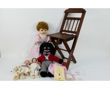 Pedigree - A pedigree hard plastic doll with sleeping eye lids, 47 cm (l) approx. A folding wooden dolls chair. A Golly doll 