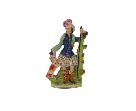 A Staffordshire portrait figure of The Prince of Wales with his dog and his hand resting on a staff. Circa 1848. Size. 36cm h