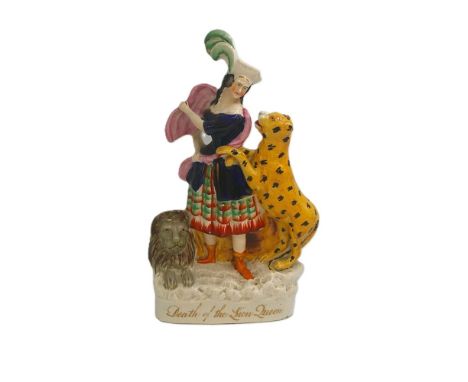 A Staffordshire portrait figure of Ellen Bright in the role of Death of The Lion Queen, standing with a lion at her feet and 