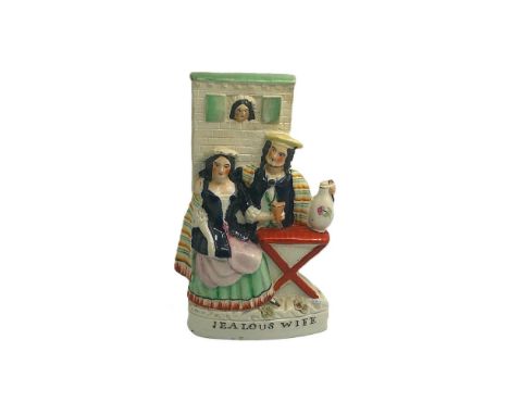 A Staffordshire portrait figure of Jealous Wife, portraying a courting couple being spied upon by his wife, Titled ‘Jealous W