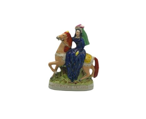 A Staffordshire portrait figure of Eugenie Empress of France on horseback.  Titled in gilt Empress of France. Circa 1855   si