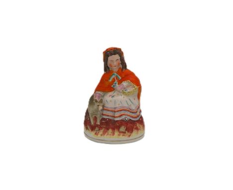A Staffordshire portrait figure of a seated Little Red Riding Hood  Circa 1860. Size 20cm high  Condition. Fire crack to back