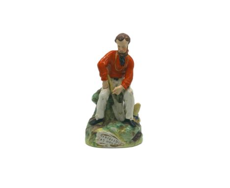 A Staffordshire portrait figure of Giuseppe Garibaldi, seated with a spade resting on his leg and his pointed hat to the side