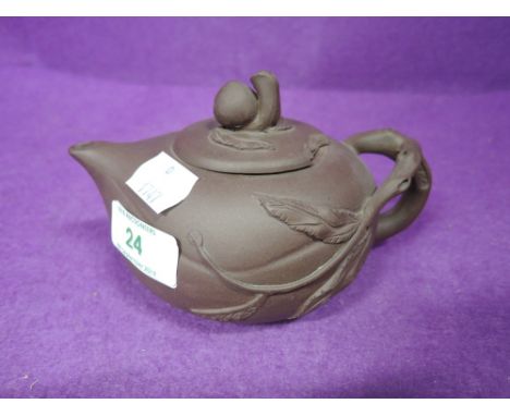 A vintage terracotta teapot with pressed mark to base