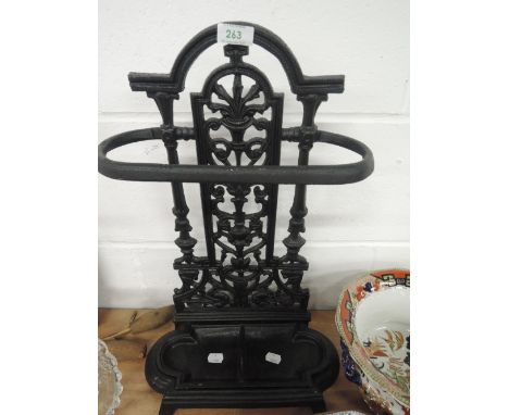 A cast iron umbrella stick stand