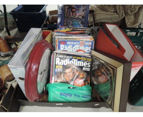 A selection of Radio times covers and vintage wall clock