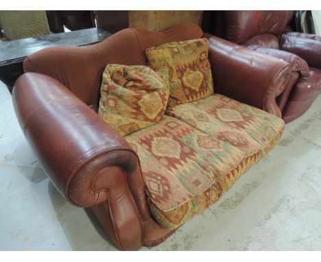 A Tetrad style part leather two seater sofa