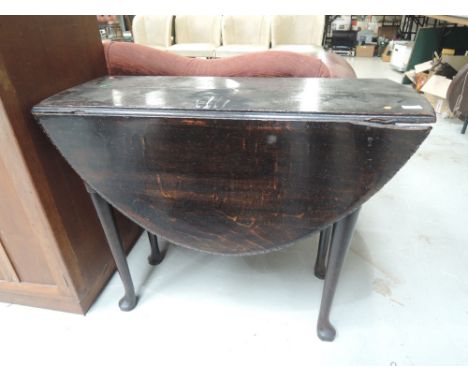 A 19th century daily oak dining table having oval drop leaf top on cabriole gate legs