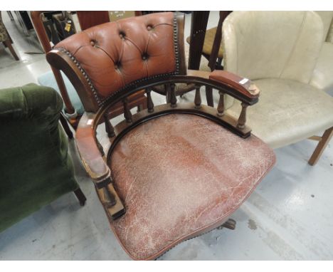 A vintage swivel office arm chair