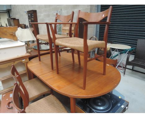 A vintage teak G-Plan style extending dining table and six (4+2) chairs