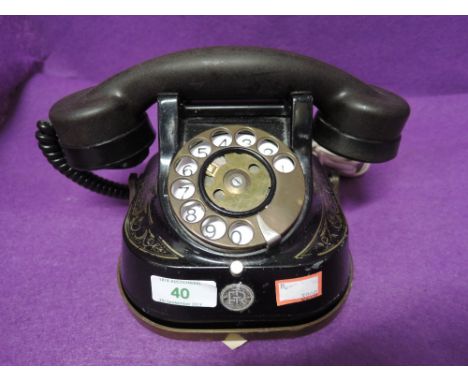 A vintage metal bodied and transfer printed telephone by Bell