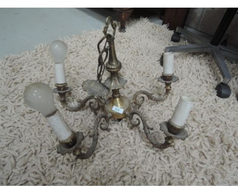 A vintage ceiling light fitting in brass