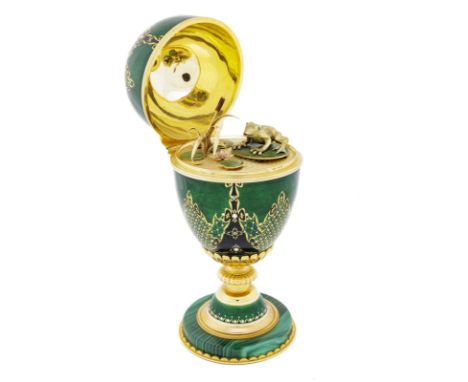 Asprey, 18K gold enamelled egg on a malachite base, opening up to reveal a swamp with lilypads and a frog hiding a mechanical