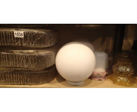 Shelf of mixed glass light shades including two globular milk glass examples. Not available for in-house P&amp;P, contact Pau