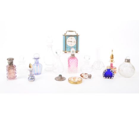 A collection of 20th century assorted perfume bottles, compact case and carriage clock. Including crystal cut glass, cranberr