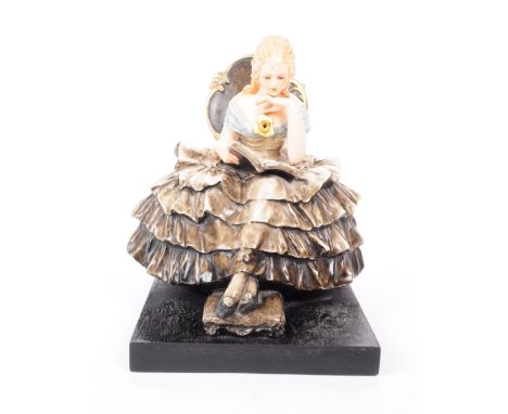 Guido Cacciapuoti - Italy (1892 - 1953) ceramic seated Crinoline lady figure reading a book. Signed to the reverse of the fig