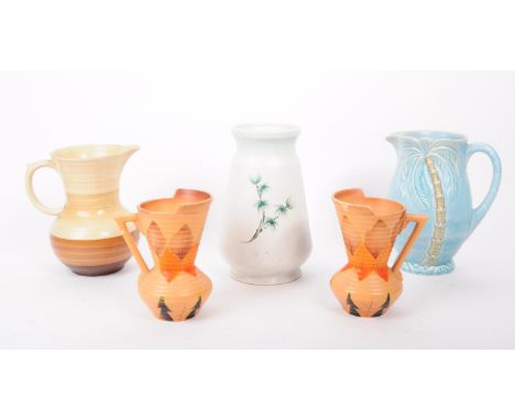 A collection of five art deco style studio pottery vases / jugs, comprised of two Ionia jugs, a Beswick 1073 blue palm tree j