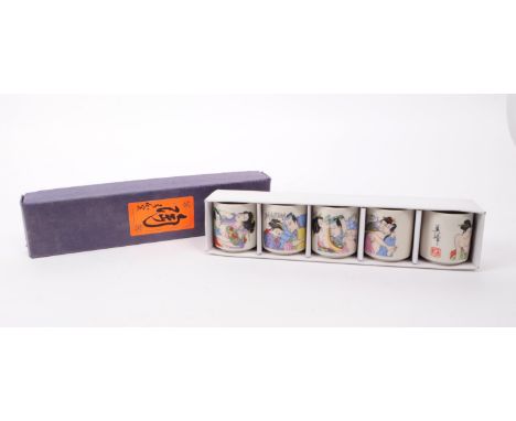 A vintage 20th century Japanese ceramic sake cup set. The set featuring erotic imagery. In original box.