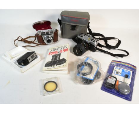 A vintage Minolta X-300 camera with a Minolta MD Zoom 35-70mm 1:3.5 lens in collaboration with Leica, a Kodak Retinette 1B ca