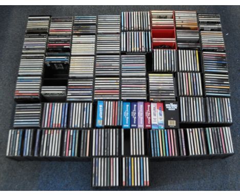 A large collection of late 20th century rock and pop cd albums, including names such as Fleetwood Mac, Kate Bush, Pink Floyd,