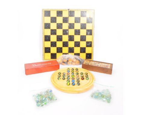 Collection of vintage 20th century games including a folding draughts board, draughts counters, dominoes, solitaire board and