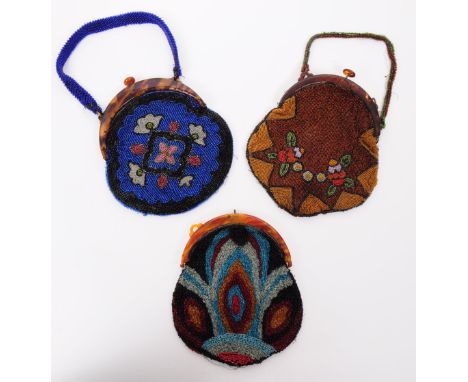 A collection of three French vintage 20th century art noueavu style beaded evening purse bags. In blue, black, browns, reds a