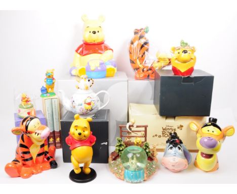 A collection of contemporary Winnie the Pooh collectable pieces. Examples including a Disney store Tigger money bank, a Disne