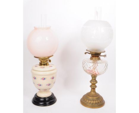 Two 20th century oil lamps, comprised of a dulex brass framed oil lamp with glass chimney, glass reservoir and frosted floral