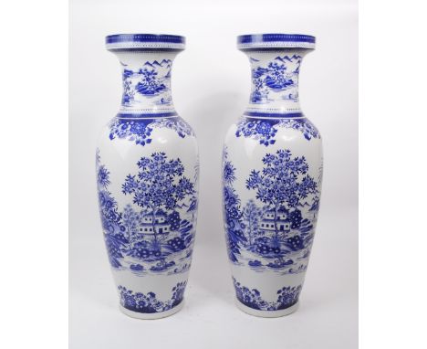 A pair of contemporary Chinese blue and white ceramic vases. The transfer print depicts an Asian Chinese landscape scene with