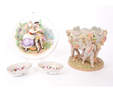 A collection of 20th century German porcelain dishes and bowl, comprised of two small trinket dishes, a bisque circular wall 