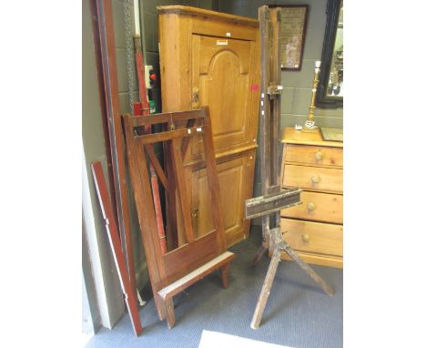 An Edwardian easel by Robinson & Co; another easel on a tripod base and a tapestry hanging pole (3)  