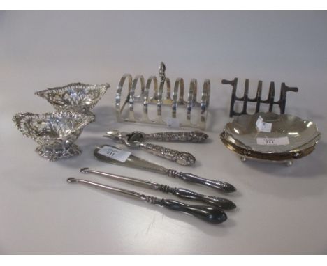 A collection of silver items including two dishes, two pierced dishes, two toast racks, two button hooks, a shoe horn and a p