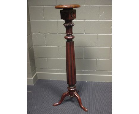 A mahogany tripod torchere 139cm high  