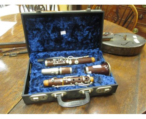 A Rudall Carte & Co, London, cased clarinet and three violin bows  