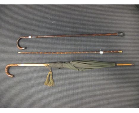 A faux bamboo walking stick with 18ct gold top, together with an umbrella and another walking stick (3)  