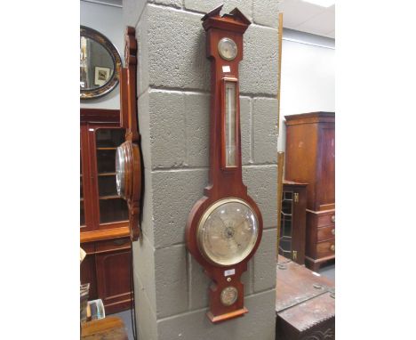 A mahogany wheel barometer by Negretti and Zambra, and a carved walnut wheel barometer (2)  