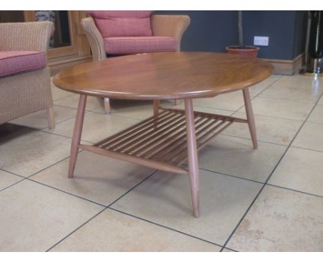 An Ercol light elm oval occasional table with undertier 44 x 100 x 82cm  