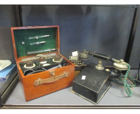 A vintage telephone handset, Kodak Bantam No.24 box camera with original box, and a Roger's Vitalator theraputic electric app
